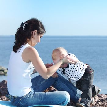 happy mother and son on picnic near sea