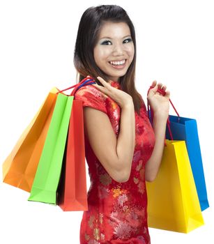 Oriental woman in red Traditional Chinese Cheongsam with shopping bag