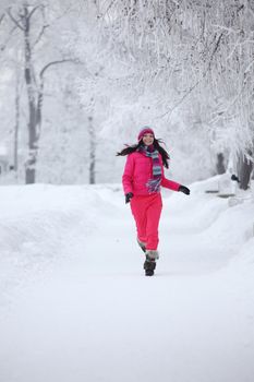 woman run in winter park very happy