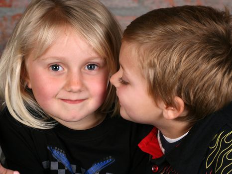 Beautiful young girl with blond hair and her cute boy friend 