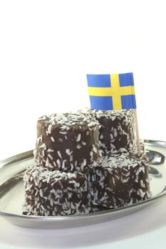 Swedish balls stacked on a tray before a white background