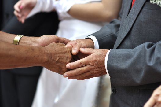 Hand shaking and welcoming guest during wedding day.