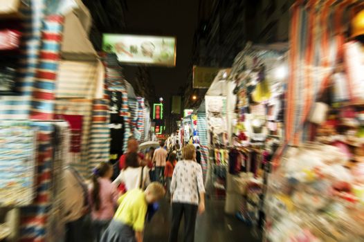 Shopper at Hong Kong night market, purposely blurred.