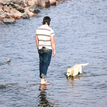 man and dog in water