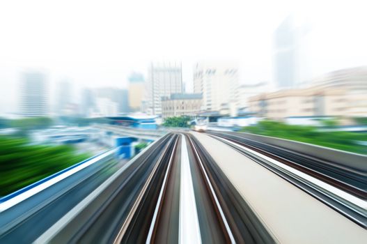 Sky Train moving fast in a hazy city.