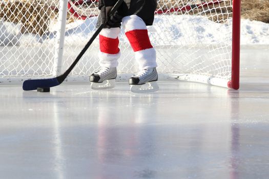 Young child playing outdoor pond ice hockey 