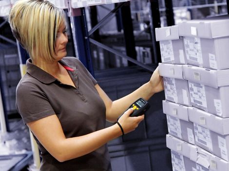 worker scans pallets and boxes in the warehouse