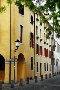 corner of yellow building with street light on piazza Capitaniato in Padua, Italy