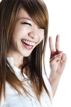 Cute asian young woman showing the peace / victory hand sign.