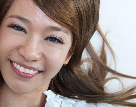 Closeup portrait of happy young girl lying on ground