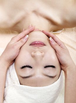 Beauty and Spa - Asian Girl having a massage on her face