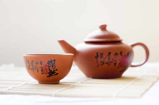 Chinese ceramic teapot and cups. The Chinese word on the pot is a poem.