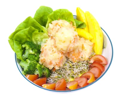 A plate of fresh vegetarian potato salad with fruits and vegetables isolated on white.