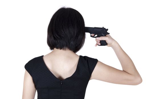 Woman with pistol pointing on her head, rear view isolated on white.