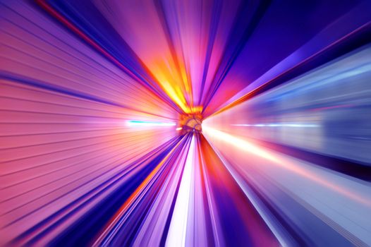Fast train passing in a neon light tunnel
