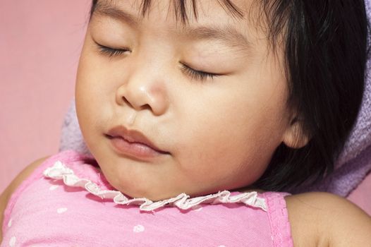 Sleeping Asian child having a sweet dream