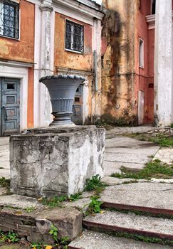 decorative urn near old buildings