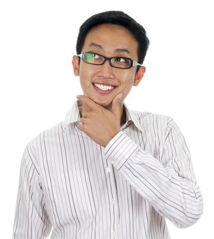 Close up of a young Asian man thinking, looking to side.