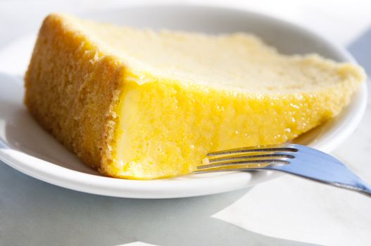 Slice of lemon butter cake, photo taken with natural sunlight in morning.