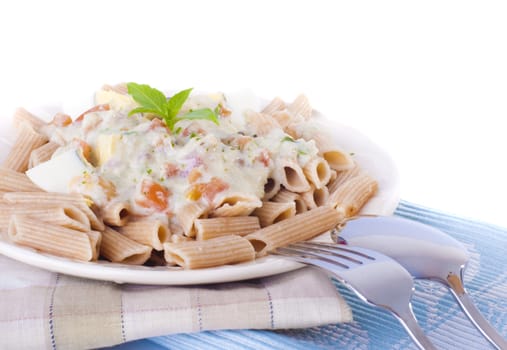 Carbonara pasta with egg, tomato, and basil leaf