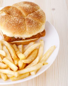 Fish burger and French Fries on plate