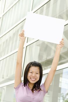 Beautiful businesswoman with blank paper for advertisement