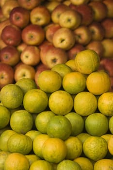 Piles of oranges and aples on a market stall in Calcutta, West Bengal, India