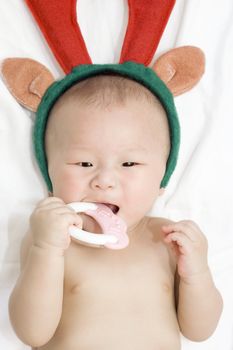 Asian baby with deer horn on head
