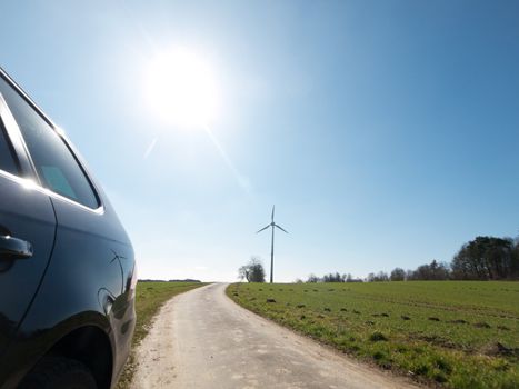 Sustainable energy concept with car wind turbine and sun
