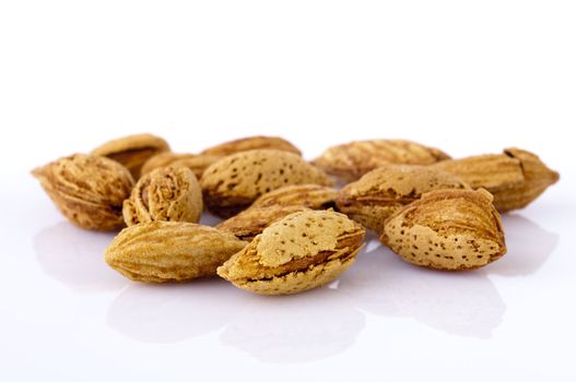 Closeup view of roasted almonds in shell.