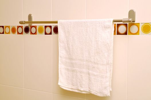 The towel hangs on a hanger in a bathroom