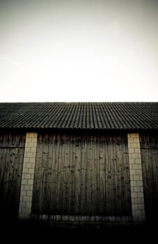 detail of vintage barn made of wood and white stone