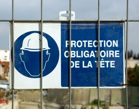 mandatory helmet, poster at the entrance of a building site in France