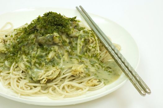 Asian noodles with fish meat, seaweed and mushroom source 

