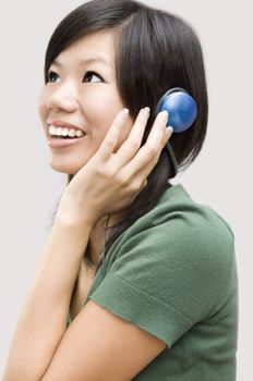 Woman wearing headphones, listening to music 