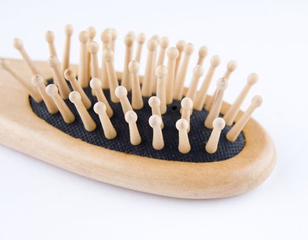 Wooden comb for hair on plain background.