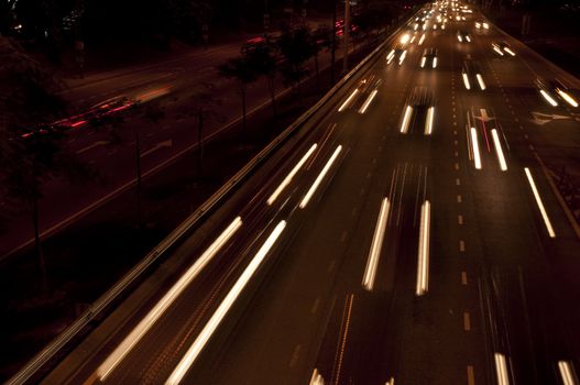 Cars moving on busy roads at night.