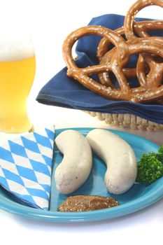 veal sausage with sweet mustard and pretzels on a white background