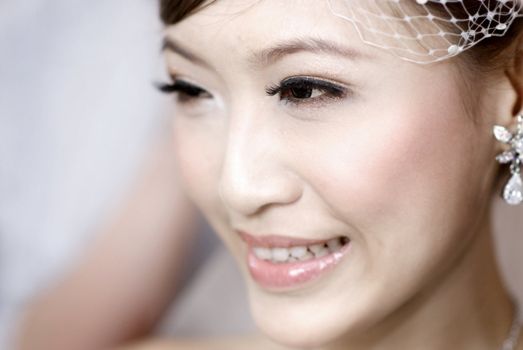 Beautiful young Asian bride smiling.