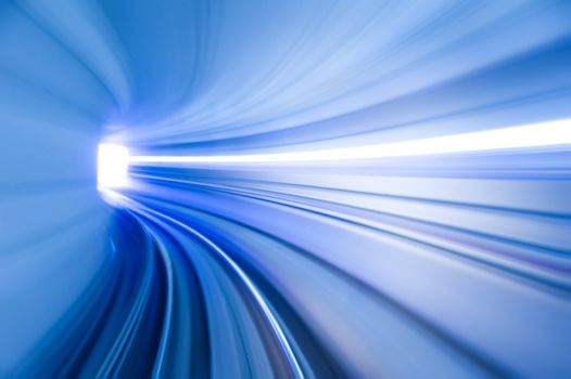 Photo looking in front of an airport train inside tunnel.