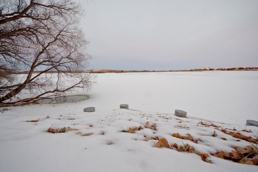 Wascana lake in Regina, Saskatchewan beginning to freeze during the cold winter days in November