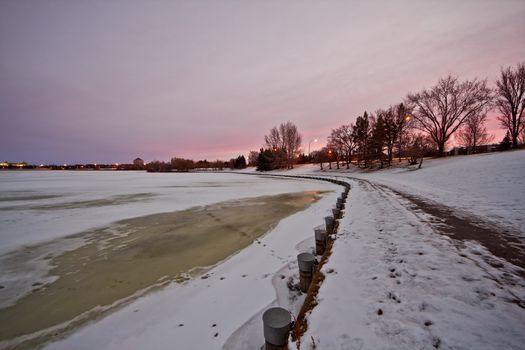 Wascana lake in Regina, Saskatchewan beginning to freeze during the cold winter days in November