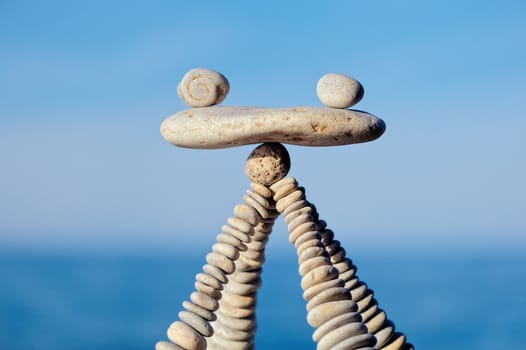 Balancing of white stones on the top of pyramidal stack