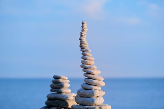 Pile of small pebbles in the balance on the seacoast