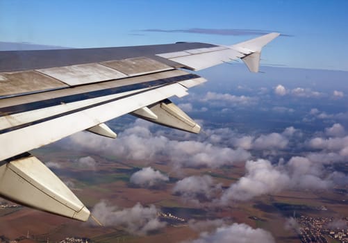 in the air, planet earth from an airplane, seen through the clouds