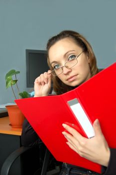 Businesswoman in glasses checking some paperwork