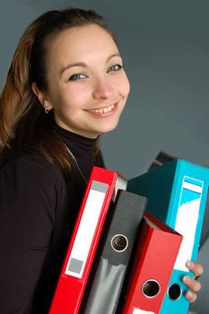 Smiling woman with lot of paperwork to do