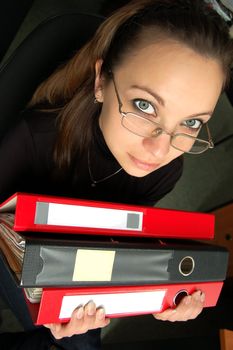 Stressed woman with lot of paperwork to do