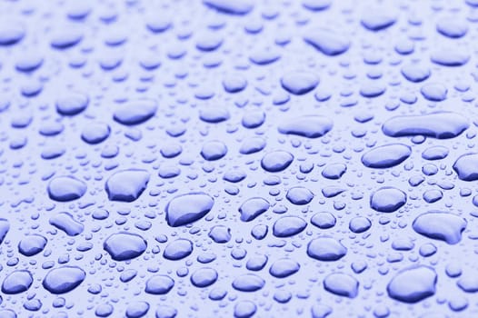 a picture of water drops on metal surface