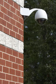 a picture of a surveillance camera on a brick wall